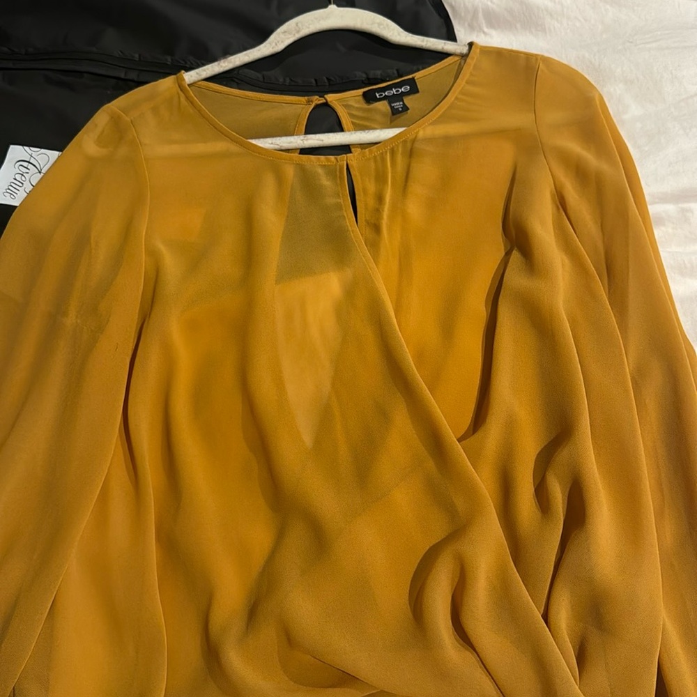 BEBE OPEN BACK AND OPEN BUST BLOUSE